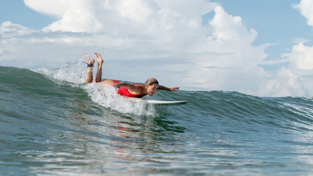 women trying to atch wave in tropics