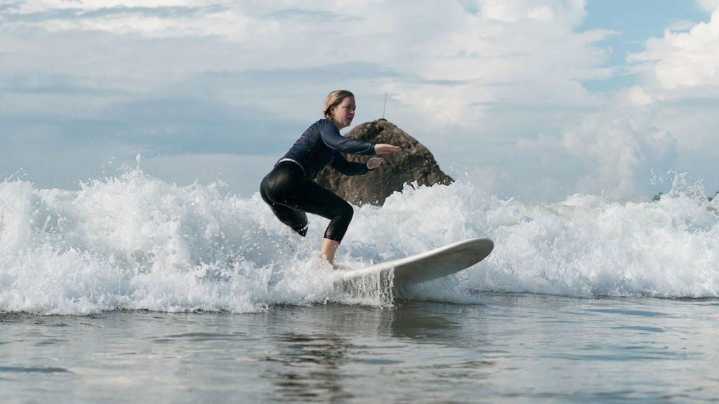 Beginner surfer catching first wave at Soul & Surf Sri Lanka