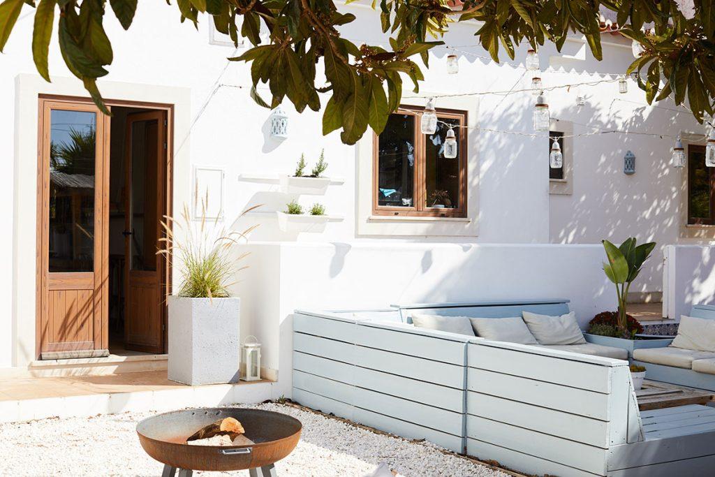 Communal outdoor lounge setup at Soul & Surf Portugal, long wooden table 