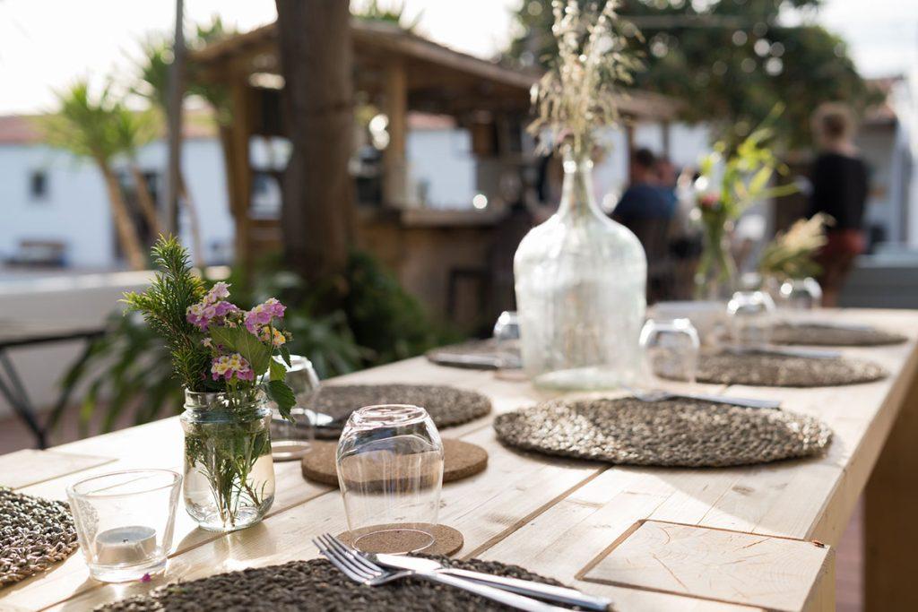 Communal dinner setup at Soul & Surf Portugal, long wooden table with guests eating together
