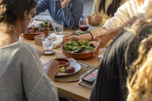 Guests sharing a meal around a table at Soul & Surf Portugal