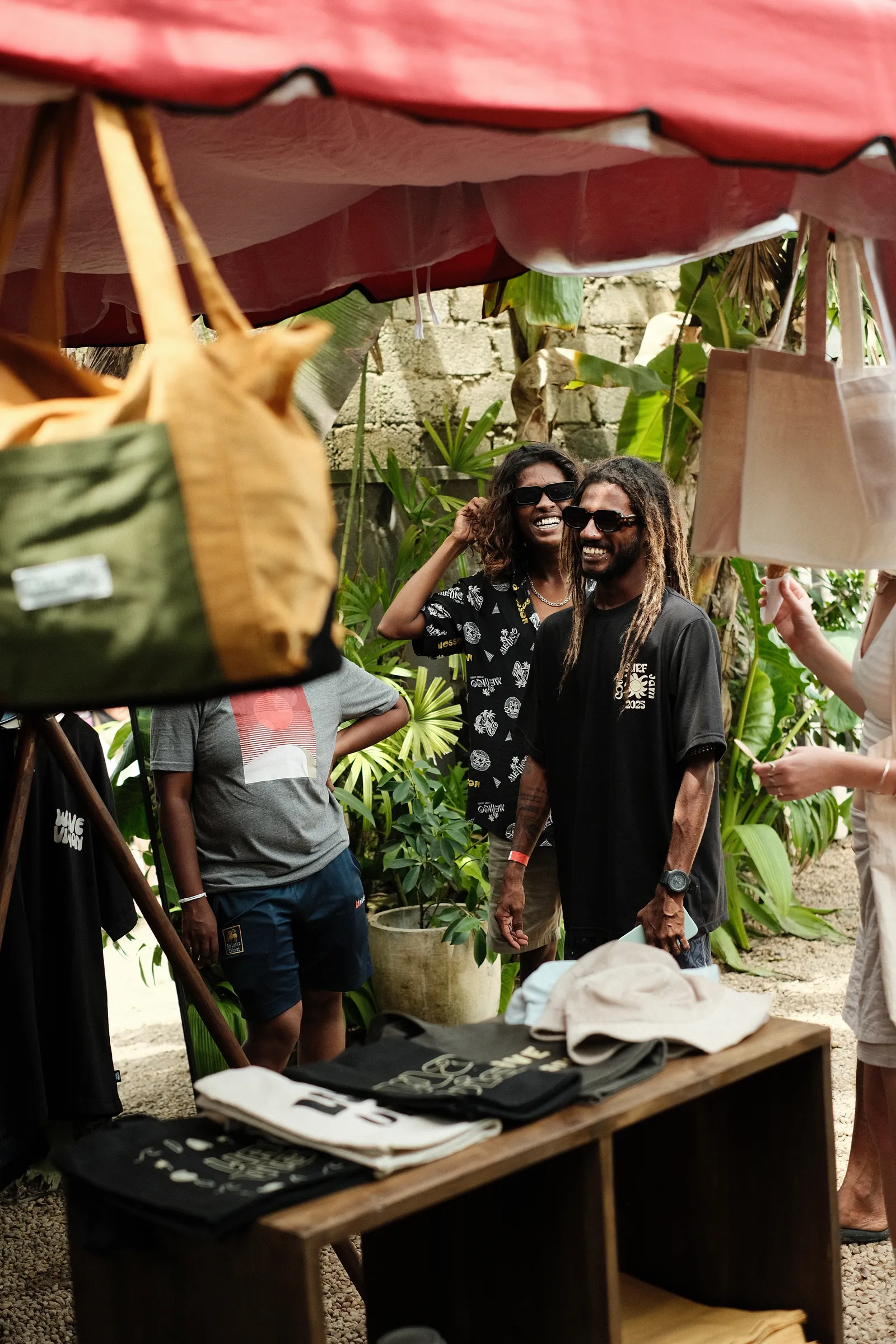 Printed Cove Surf Jam T-shirts and tote bags on the rail of the pop-up shop
